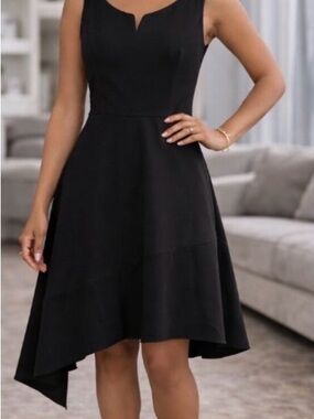 Donna Karan Black À-Line elegant dress with gold accent zippers with pockets.